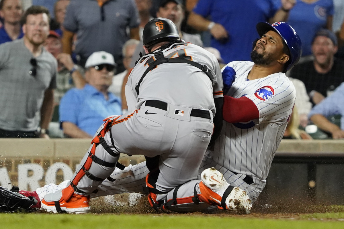 Chicago Cubs third baseman Jeimer Candelario collides with SF Giants catcher Patrick Bailey during the seventh inning at Wrigley Field on September 5, 2023.